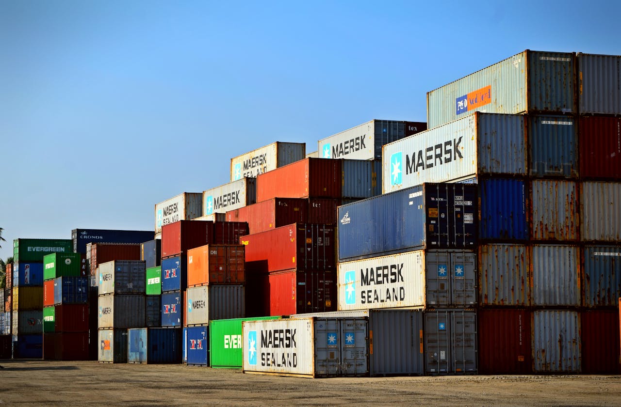 mobile-01 Colorful stacked shipping containers at a port exemplify global logistics.